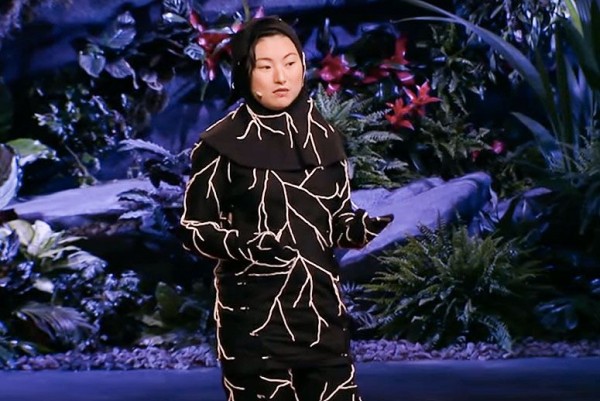 Jae Rhim Lee doing a TED Talk in her mushroom burial suit. 