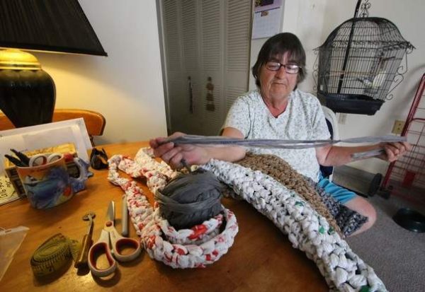 Virgina Wingate crochets sleeping mats for homeless people out of plastic grocery bags in her Daytona Beach apartment.