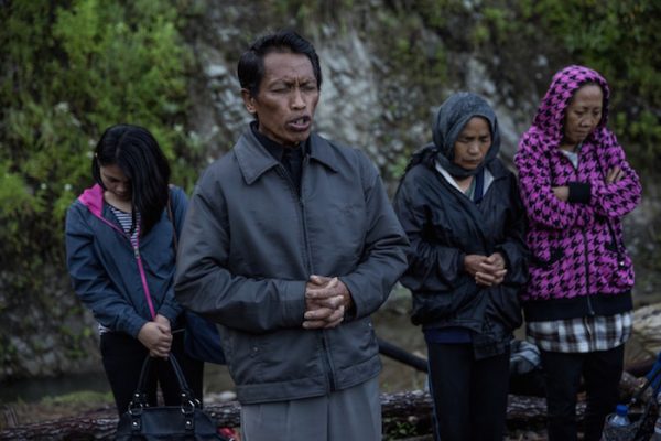 Villagers pray before they perform the Ma’Nene ritual in Barrupu village, Toraja, South Sulawesi, Indonesia.