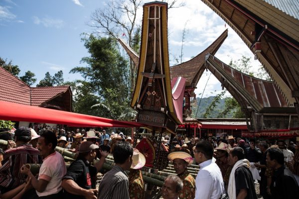 Villagers and relatives gather as they prepare for a parade during the Rambu Solo of V.T. Sarangullo in La’Bo village, Toraja, South Sulawesi, Indonesia. After the animals are killed, a feast is thrown and the body of the deceased placed in a stone grave, or Liang.
