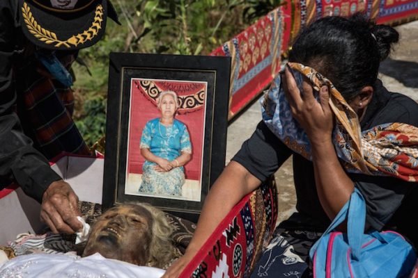 A woman cries in front of the corpse of Marta Ratte Limbong during the Ma’Nene ritual in Ba’Tan Village, Toraja, South Sulawesi, Indonesia. Locals believe dead family members are still with them, even if they died hundreds of years ago. 