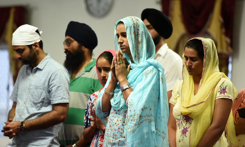 Mourners attend a vigil for bus driver Manmeet Alisher at a Sikh temple in Brisbane, after he was burned alive when an incendiary device was allegedly thrown at him while he was letting passengers on at Moorooka
