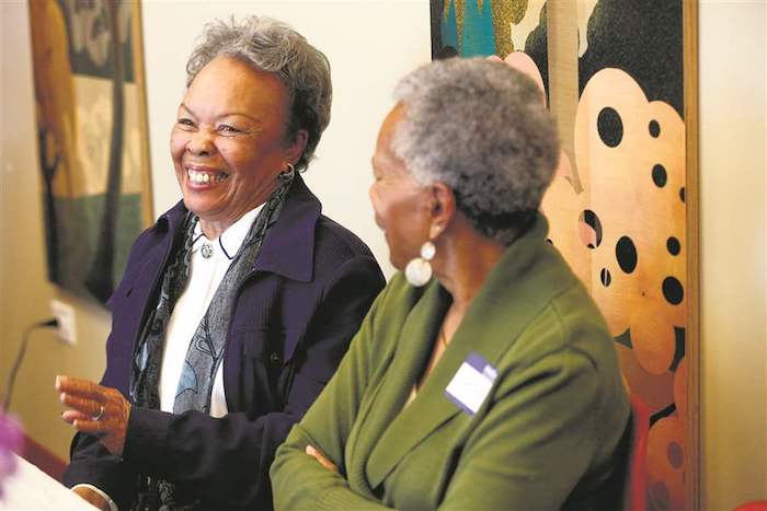 Alice Bishop, left, of Toledo, shares a story while laughing during a support group for widows.